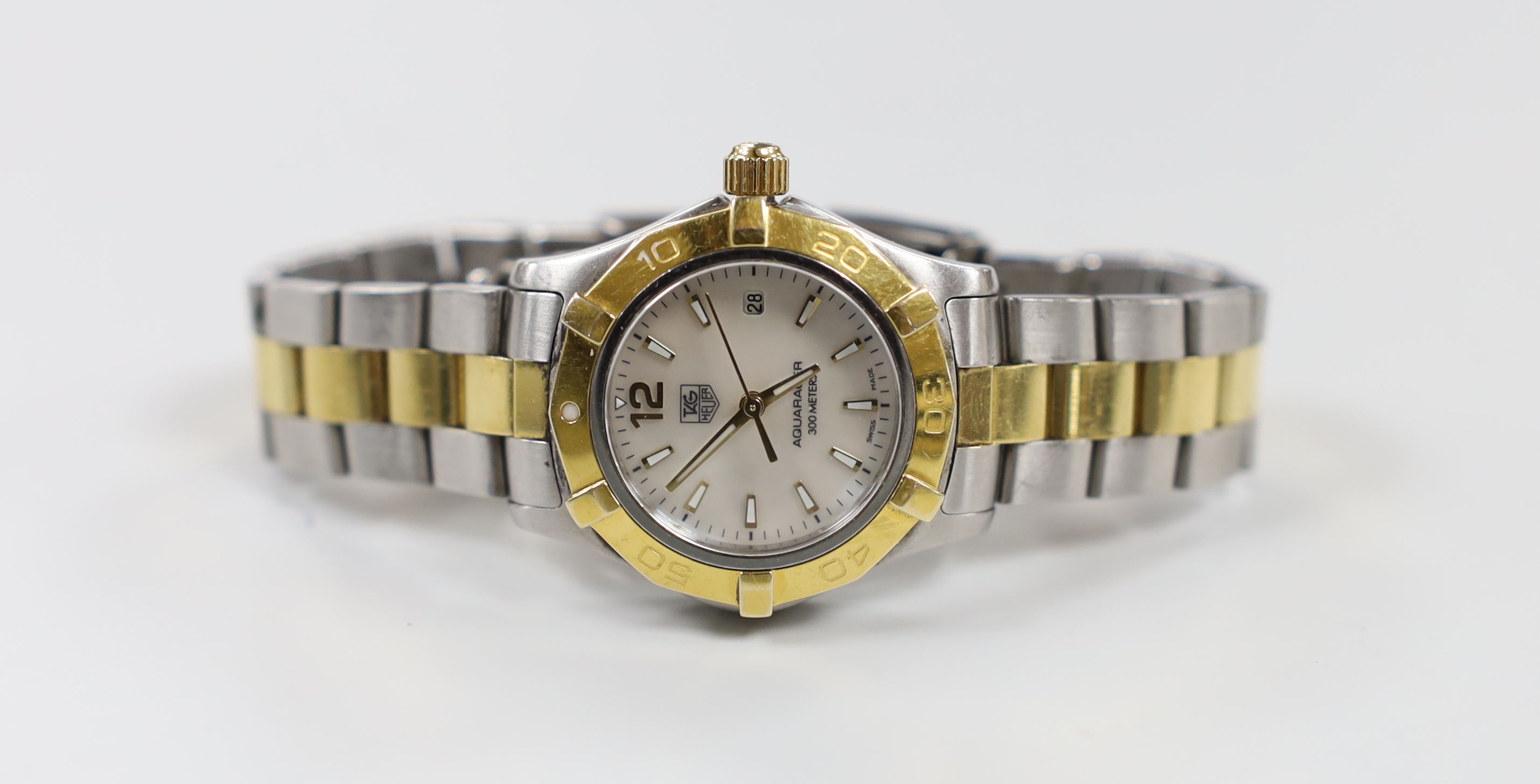 A lady's modern steel and gold plated Tag Heuer Aquaracer quartz wrist watch, with mother of pearl dial, no box or papers, with spare link.